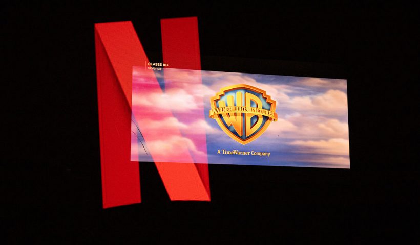 Double exposure photograph of the Netflix logo and the Warner Bros logo on a television screen at Kerlouan in Brittany in France on December 05 2025. (Photo by Vincent Feuray / Hans Lucas / AFP via Getty Images)