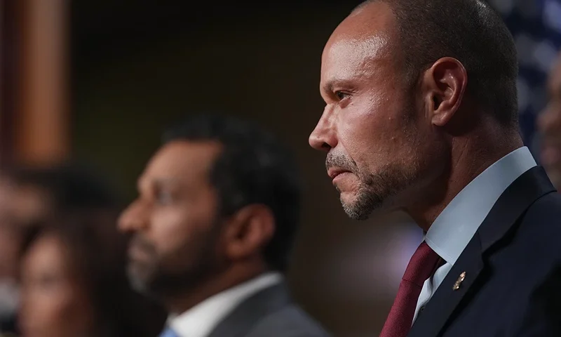 WASHINGTON, DC - DECEMBER 04: Dan Bongino, Deputy Director of the FBI listens to speakers during a news conference about the January 6th pipe bomber at the Department of Justice on December 4, 2025 in Washington, DC. Federal agents have arrested a suspect they are charging with placing two pipe bombs, which never exploded, the night before the January 6th, 2021 U.S. Capitol attack. (Photo by Andrew Harnik/Getty Images)