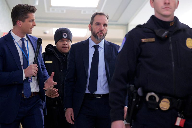 WASHINGTON, DC - DECEMBER 17: Former Special Counsel Jack Smith (C) is trailed by members of the media as he arrives to testify during a closed-door deposition before the House Judiciary Committee in the Rayburn House Office Building on Capitol Hill on December 17, 2025 in Washington, DC. Smith was appointed independent special counsel by Attorney General Merrick Garland in 2022 to oversee two criminal investigations into former President Donald Trump's role in the January 6, 2021 attack on the U.S. Capitol and mishandling of classified documents. Both cases were eventually dismissed and Trump went on to win his second presidential election in 2024. (Photo by Chip Somodevilla/Getty Images)