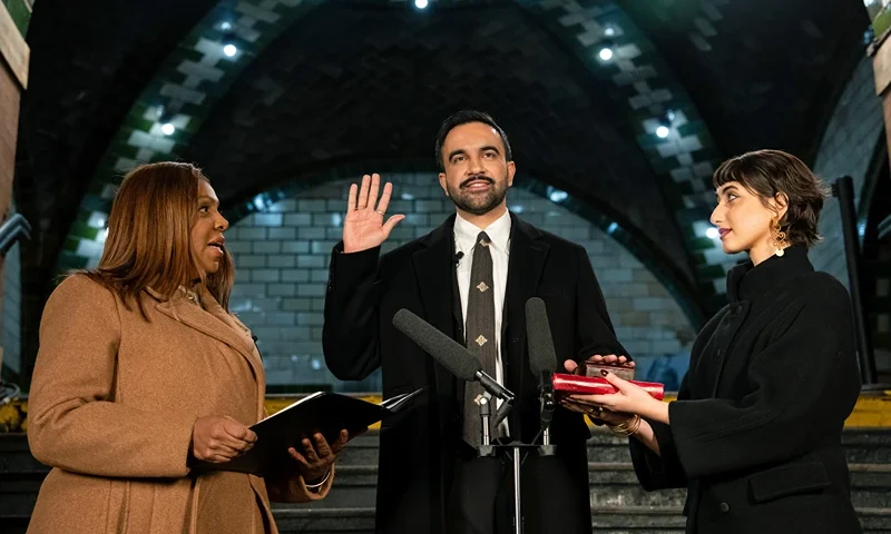 NEW YORK, NEW YORK - JANUARY 1: Zohran Mamdani is sworn in as New York City's 112th mayor by New York Attorney General Letitia James, left, alongside his wife Rama Duwaji, right, in the former City Hall subway station on January 1, 2026 in New York City. Mamdani’s term as mayor begins immediately in the new year, and a public inauguration will also take place in the afternoon at City Hall. (Photo by Amir Hamja-Pool/Getty Images)