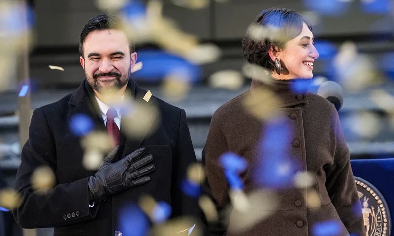 NEW YORK, NEW YORK - JANUARY 01: New York Mayor Zohran Mamdani and his wife Rama Duwaji smile as confetti falls after his ceremonial inauguration as mayor at City Hall Thursday January 1, 2026 in New York, NY. Mamdani has added a “block party” to the official inauguration events to allow thousands of New Yorkers to take part. Mamdani was officially sworn in at midnight by New York Attorney General Letitia James at the Old City Hall subway station in a private ceremony. (Photo by David Dee Delgado/Getty Images)