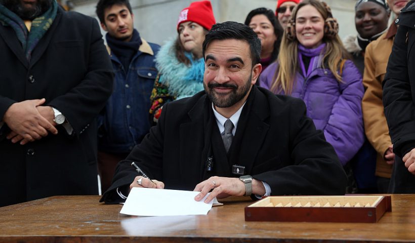 NEW YORK, NEW YORK - JANUARY 02: New York City Mayor Zohran Mamdani signs executive orders with campaign volunteers during an appearance at Grand Army Plaza in Brooklyn on January 02, 2026, in New York City. The newly inaugurated mayor has revoked a number of executive orders issued by former New York City Mayor Eric Adams, including some related to Israel. (Photo by Spencer Platt/Getty Images)