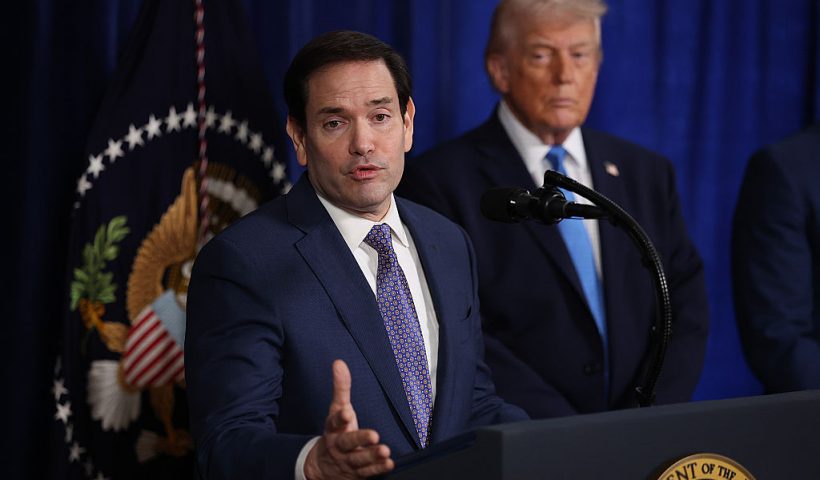 PALM BEACH, FLORIDA - JANUARY 03: U.S. Secretary of State Marco Rubio speaks during a press conference as U.S. President Donald Trump listens at Mar-a-Lago club on January 03, 2026, in Palm Beach, Florida. During the event, President Trump confirmed that the U.S. military carried out a large-scale strike in Caracas overnight, resulting in the capture of Venezuelan leader Nicolas Maduro and his wife, Cilia Flores. (Photo by Joe Raedle/Getty Images)