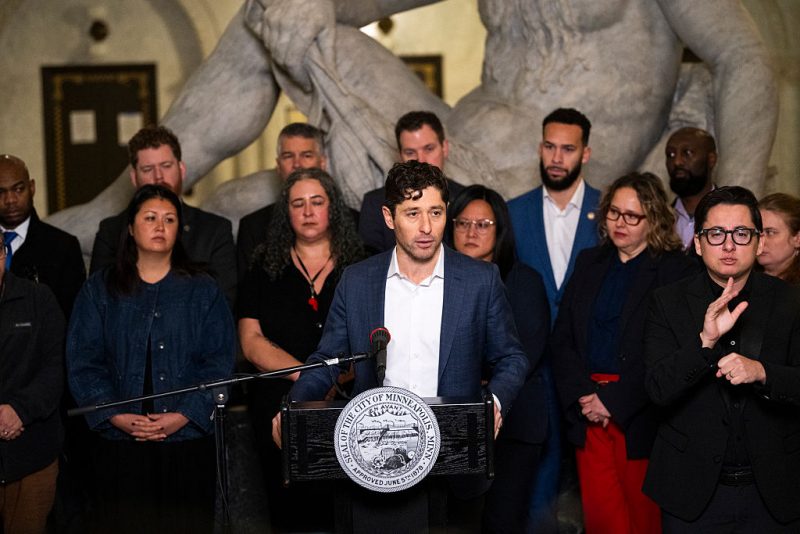 MINNEAPOLIS, MINNESOTA - JANUARY 09: Minneapolis Mayor Jacob Frey (C) speaks during a press conference at City Hall on January 09, 2026 in Minneapolis, Minnesota. Frey and local city officials are calling on federal investigators to turn over information to the Minnesota Bureau of Criminal Apprehension after the shooting death of Renee Good by a federal officer this week. (Photo by Stephen Maturen/Getty Images)