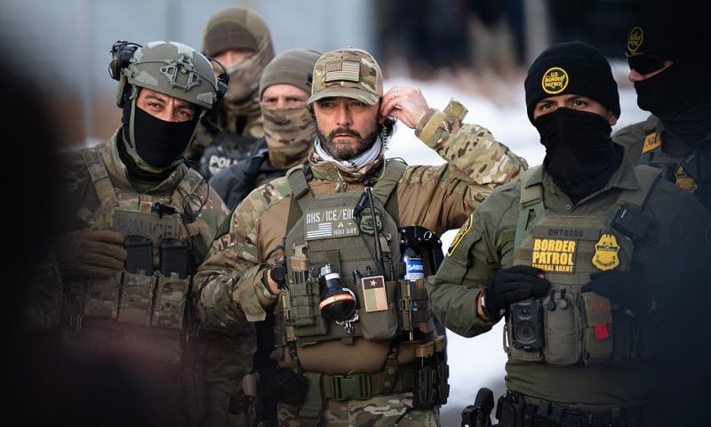 MINNEAPOLIS, MINNESOTA - JANUARY 10: Federal agents stage at a front gate as Rep. Ilhan Omar (D-MN), Rep. Kelly Morrison (D-MN), and Rep. Angie Craig (D-MN) attempt to enter the regional ICE headquarters at the Bishop Henry Whipple Federal Building on January 10, 2026 in Minneapolis, Minnesota. The Congresspeople were briefly allowed access to the facility where the Department of Homeland Security has been headquartering operations in the state. (Photo by Stephen Maturen/Getty Images)