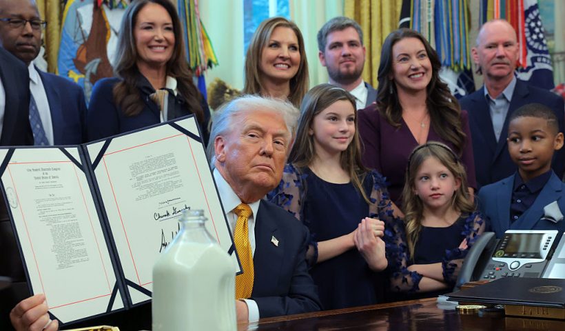 WASHINGTON, DC - JANUARY 14: U.S. President Donald Trump displays a signed bill during an event with dairy farmers in the Oval Office of the White House on January 14, 2026 in Washington, DC. Trump signed a series of bills including the "Whole Milk for Healthy Kids Act" to allow the sale of whole milk in school cafeterias across the country. (Photo by Anna Moneymaker/Getty Images)