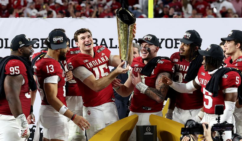 MIAMI GARDENS, FLORIDA - JANUARY 19: Fernando Mendoza #15 of the Indiana Hoosiers celebrates with the College Football Playoff National Championship Trophy after defeating Miami Hurricanes 27-21 in the 2026 College Football Playoff National Championship at Hard Rock Stadium on January 19, 2026 in Miami Gardens, Florida. (Photo by Jamie Squire/Getty Images)