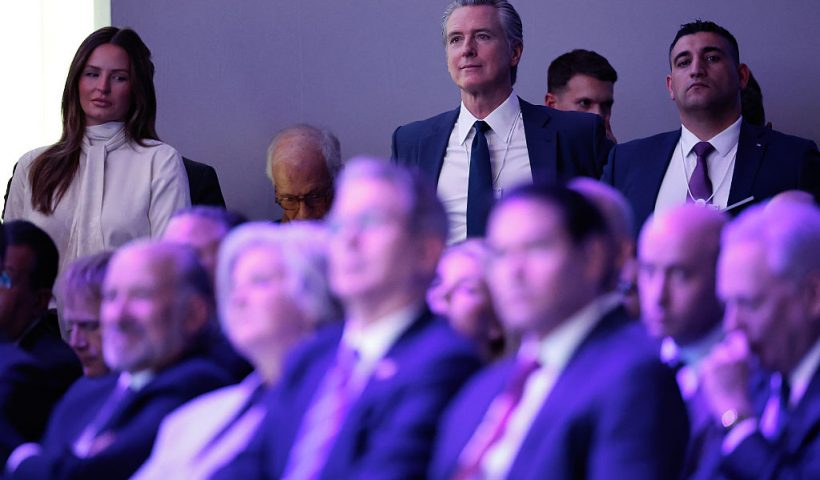 DAVOS, SWITZERLAND - JANUARY 21: California Governor Gavin Newsom (C) listens to U.S. President Donald Trump address the World Economic Forum (WEF) in the Davos Congress Center on January 21, 2026 in Davos, Switzerland. The annual meeting of political and business leaders comes amid rising tensions between the United States and Europe over a range of issues, including Trump's vow to acquire Greenland, a semi-autonomous Danish territory. (Photo by Chip Somodevilla/Getty Images)