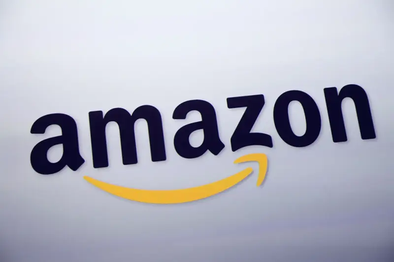 The Amazon logo is displayed at a news conference in New York on Sept. 28, 2011. (AP Photo/Mark Lennihan, File)