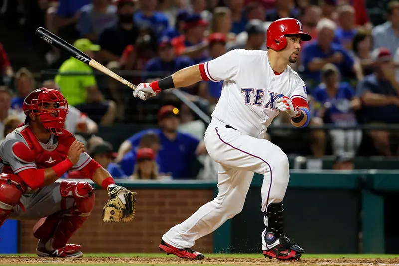 Texas Rangers’ Carlos Beltran follows through on a two-run home run swing as Los Angeles Angels catcher Carlos Perez watches in the fifth inning of a baseball game, Sept. 21, 2016, in Arlington, Texas. (AP Photo/Tony Gutierrez, File)