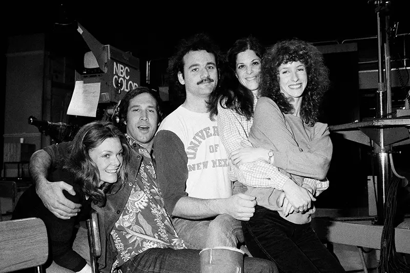 Chevy Chase, second from left, joins the cast of “Saturday Night Live,” Feb. 16, 1978 in New York. Others are, from left, Jane Curtin, Bill Murray, Gilda Radner and Laraine Newman. Chase is doing a guest shot on the program. (AP Photo/Marty Lederhandler, File)