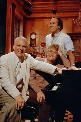 Steve Martin, Randy Newman and Chevy Chase rehearse a musical number at the NBC studios in New York’s Rockefeller Center, Dec. 5, 1986, in preparation for their reunion on “Saturday Night Live.” (AP Photo/Richard Drew, File)