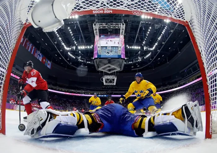 Canada forward Sidney Crosby, left, scores a goal past Sweden goaltender Henrik Lundqvist during the second period of the men’s gold medal ice hockey game, Feb. 23, 2014, at the Winter Olympics in Sochi, Russia. (AP Photo/Julio Cortez, Pool, FIle)