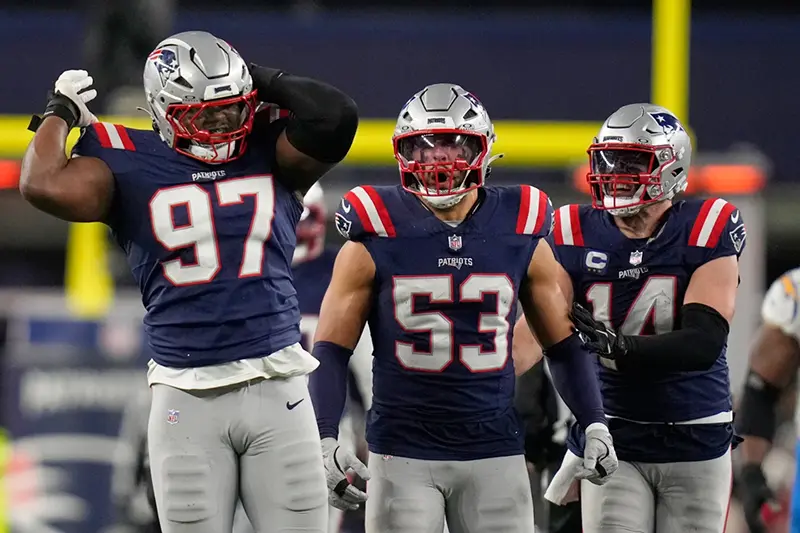 New England Patriots defensive end Milton Williams (97), linebacker Christian Elliss (53) and linebacker Robert Spillane (14) celebrate Williams’ sack of Los Angeles Chargers quarterback Justin Herbert (10) in the second half of an NFL wild-card playoff football game in Foxborough, Mass., Sunday, Jan. 11, 2026. (AP Photo/Charles Krupa)