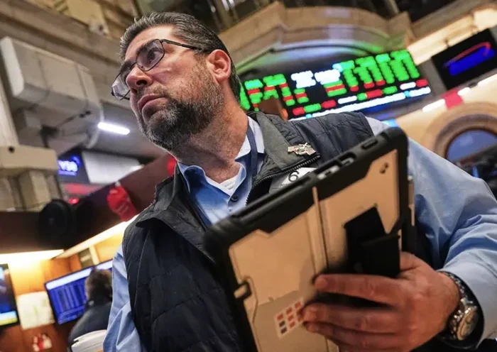 Trader Michael Capolino works on the floor of the New York Stock Exchange, Monday, Jan. 12, 2026. (AP Photo/Richard Drew)