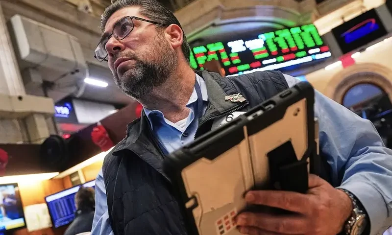 Trader Michael Capolino works on the floor of the New York Stock Exchange, Monday, Jan. 12, 2026. (AP Photo/Richard Drew)
