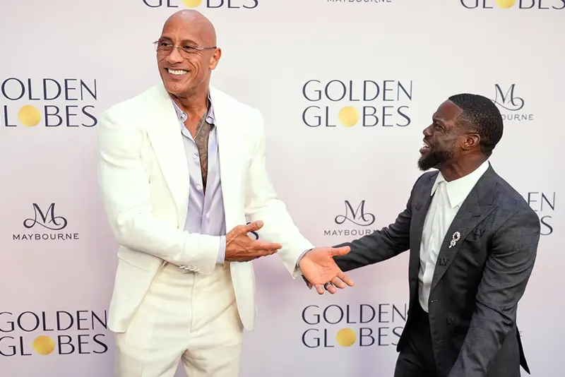Dwayne Johnson, left, shares a laugh with Kevin Hart at the Golden Globes first-time nominee celebration on Wednesday, Dec. 17, 2025, at The Maybourne Beverly Hills in Beverly Hills, Calif. (AP Photo/Chris Pizzello)