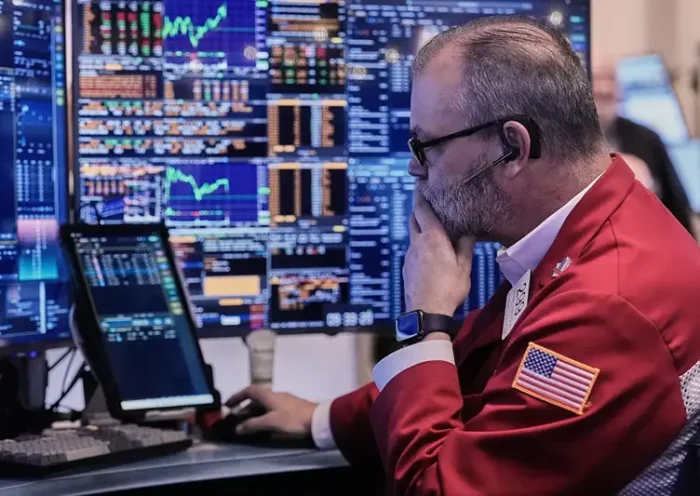 Trader William Lawrence works on the floor of the New York Stock Exchange, Wednesday, Jan. 7, 2026. (AP Photo/Richard Drew)