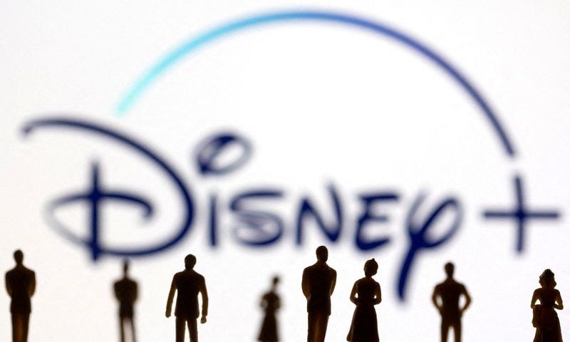 FILE PHOTO: Toy figures of people are seen in front of the displayed Disney + logo, in this illustration. REUTERS/Dado Ruvic/Illustration/File Photo