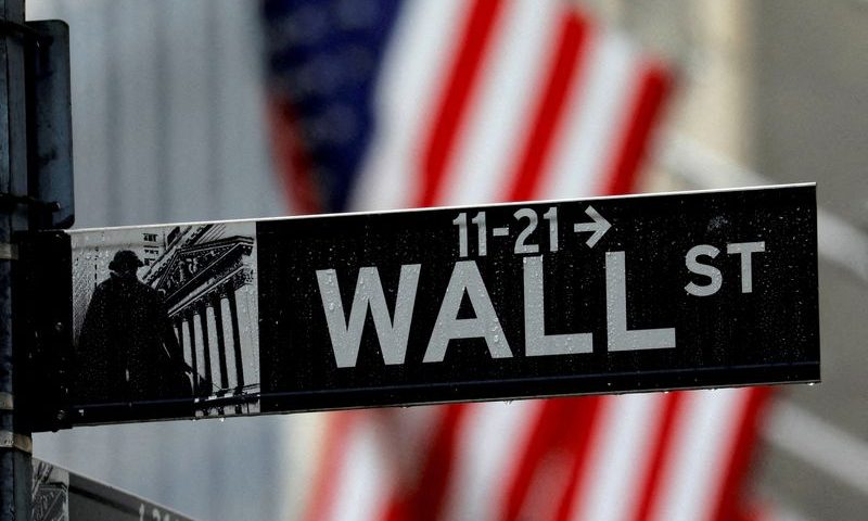 FILE PHOTO: Raindrops hang on a sign for Wall Street outside the New York Stock Exchange in Manhattan in New York City, New York, U.S., October 26, 2020. REUTERS/Mike Segar