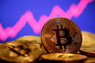 FILE PHOTO: A representation of virtual currency Bitcoin is seen in front of a stock graph in this illustration taken January 8, 2021. REUTERS/Dado Ruvic