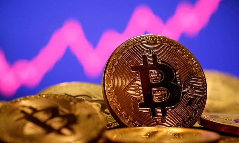 FILE PHOTO: A representation of virtual currency Bitcoin is seen in front of a stock graph in this illustration taken January 8, 2021. REUTERS/Dado Ruvic