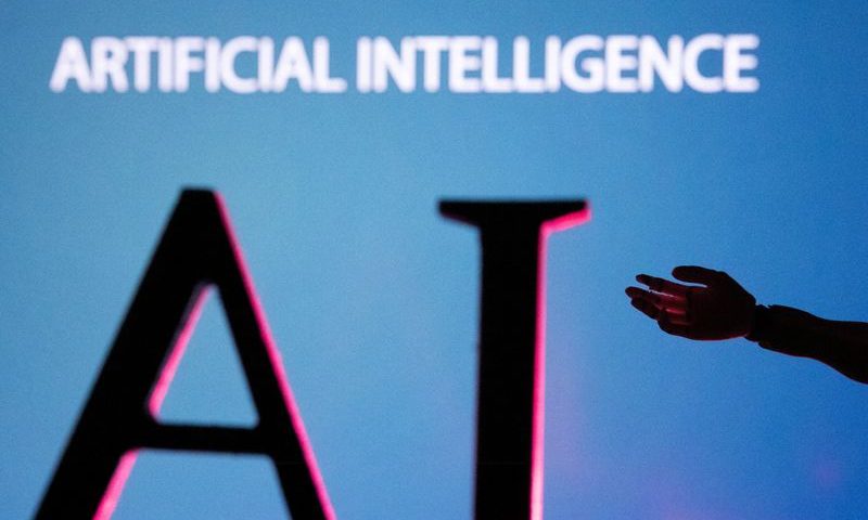 FILE PHOTO: AI (Artificial Intelligence) letters and robot hand miniature in this illustration taken, June 23, 2023. REUTERS/Dado Ruvic/Illustration/File Photo