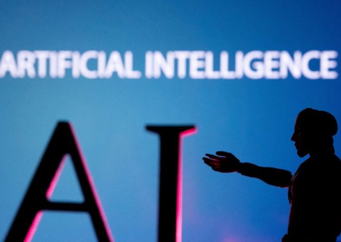 FILE PHOTO: AI (Artificial Intelligence) letters and robot hand miniature in this illustration taken, June 23, 2023. REUTERS/Dado Ruvic/Illustration/File Photo