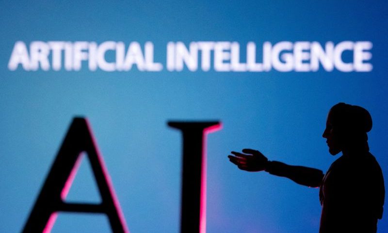 FILE PHOTO: AI (Artificial Intelligence) letters and robot hand miniature in this illustration taken, June 23, 2023. REUTERS/Dado Ruvic/Illustration/File Photo